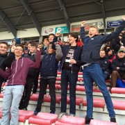 Students watching a match on tour